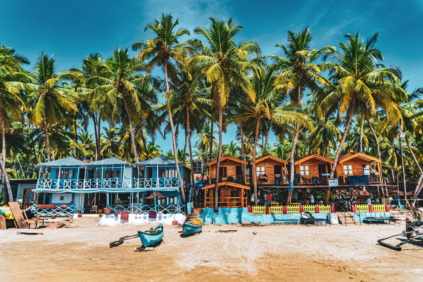Palm trees and colourful beach huts on a Goa beach