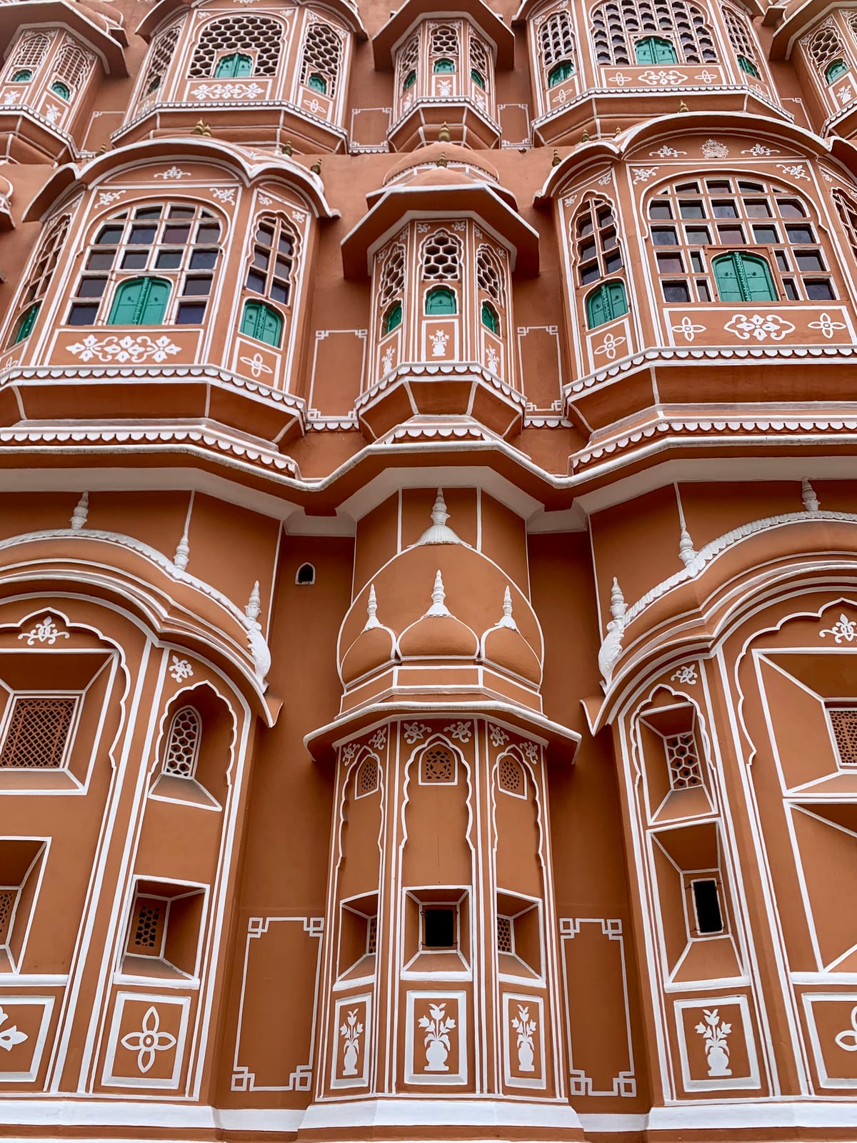 The pink sandstone facade of the Hawa Mahal in Jaipur