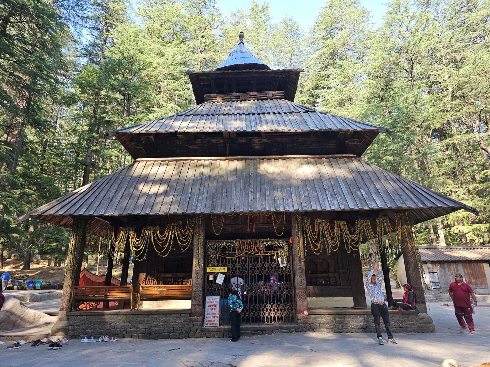 The tiered wooden pagoda of the Hadimba Devi Temple among tall cedars at Dhungri, Manali