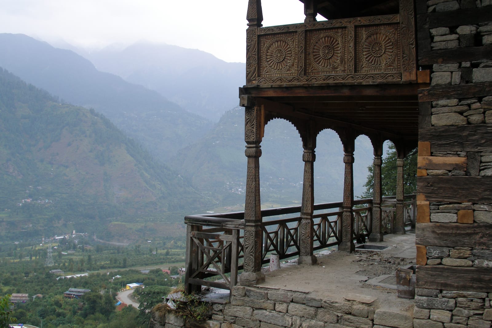 The carved wooden gallery of Naggar Castle looking out over the Kullu valley