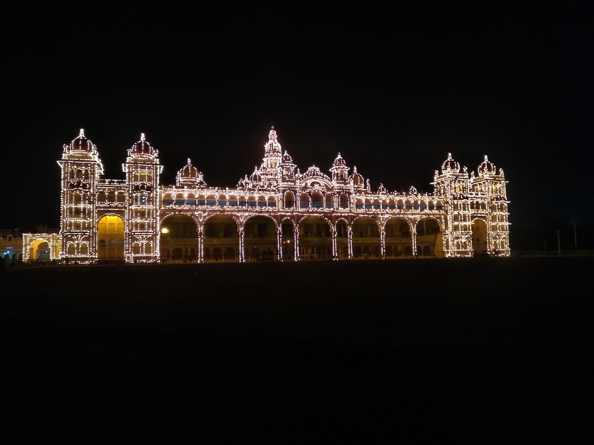 Mysore Palace outlined in thousands of lights against a black night sky