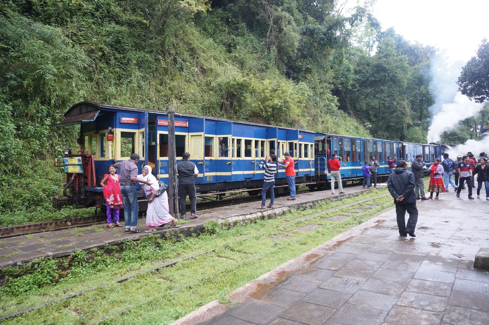 The Nilgiri Mountain Railway toy train winding through the green Nilgiri hills near Ooty