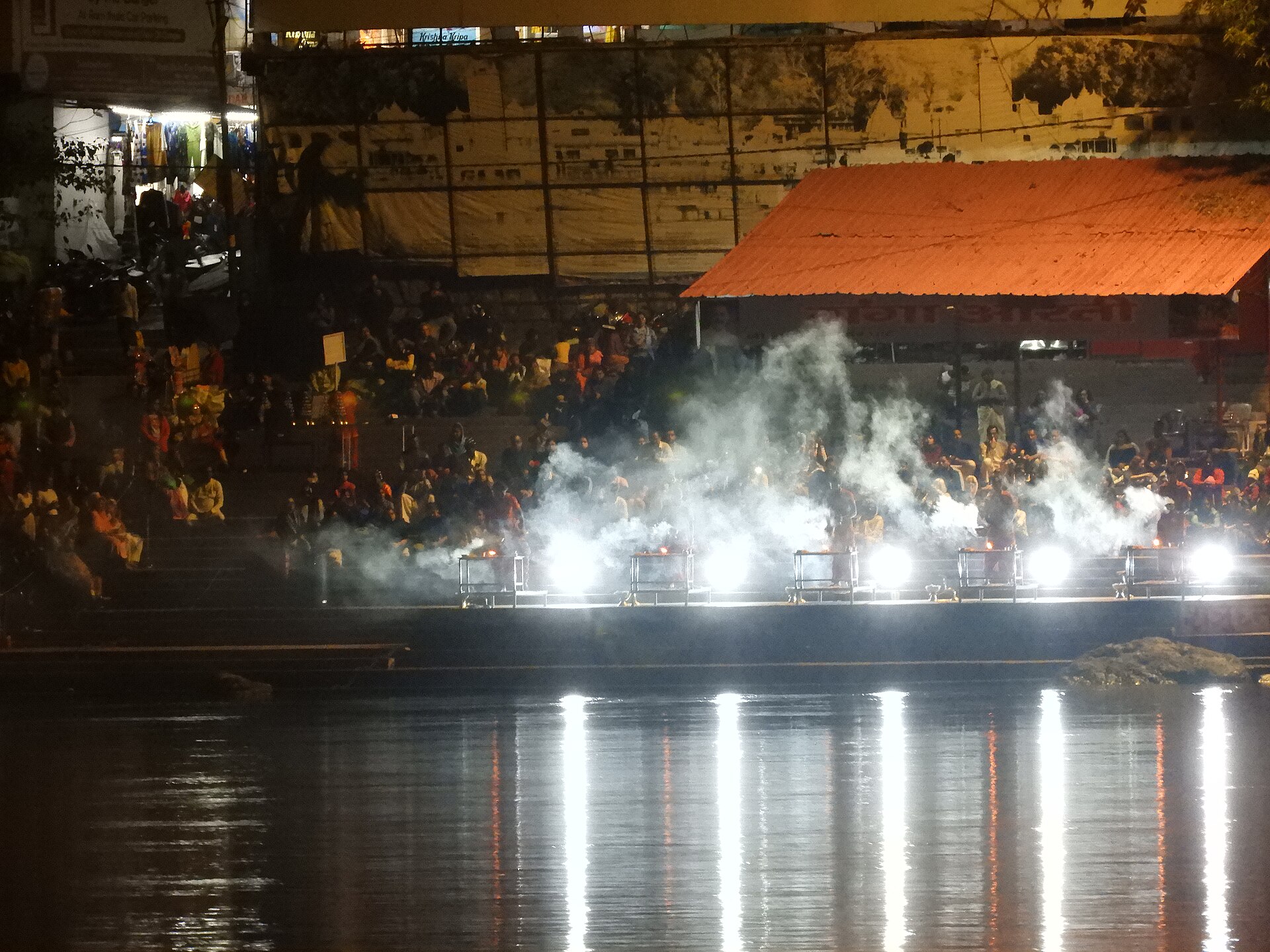 Rows of lamps and devotees at the evening Ganga Aarti on a ghat at Rishikesh near Ram Jhula