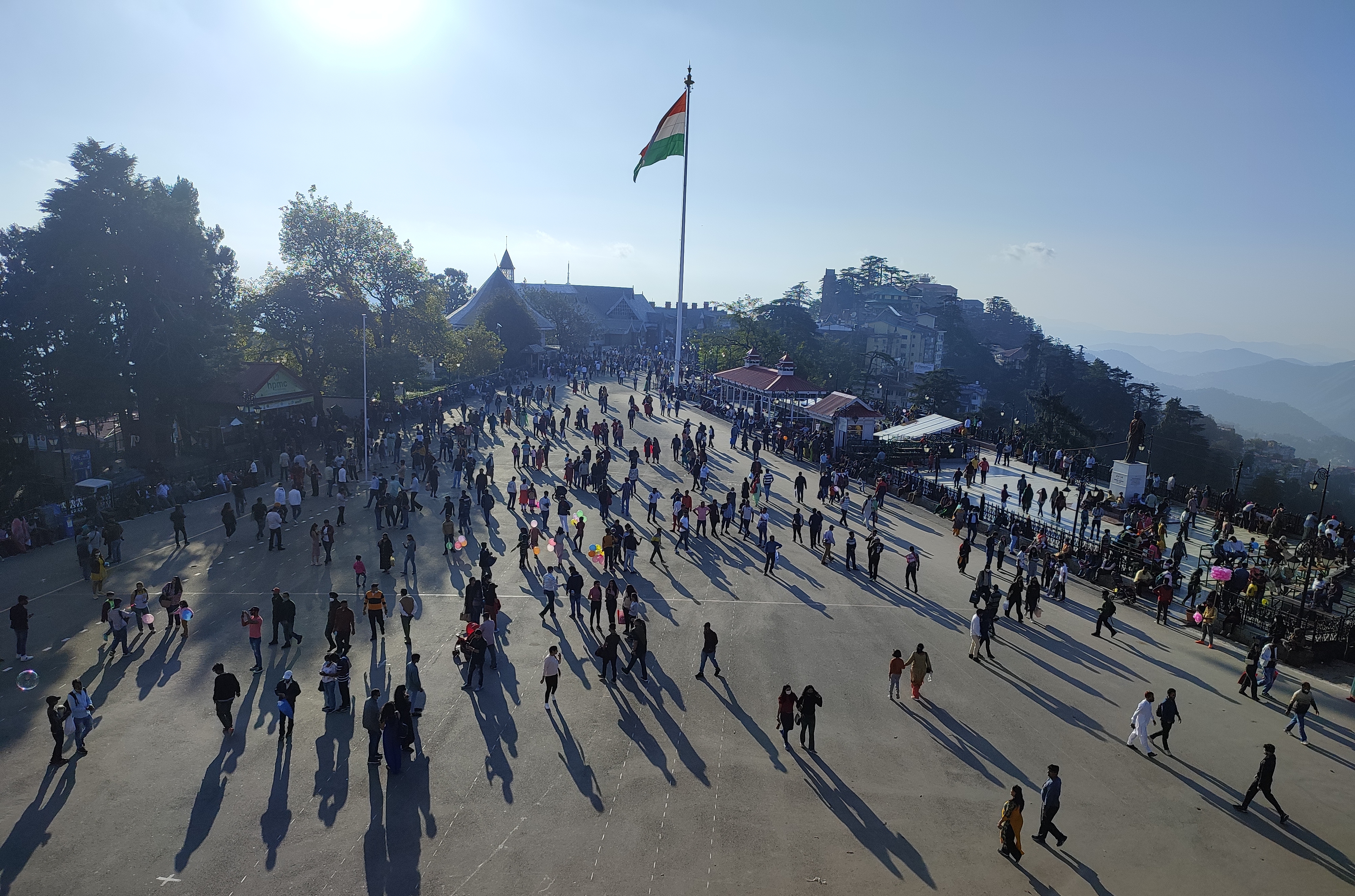 Crowds walking on the broad open Ridge in Shimla with Christ Church and the Indian flag behind